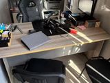 a desk with a chair and a computer on it