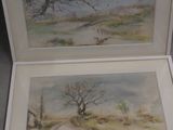 two paintings of trees in a white box on a table