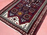an oriental rug on a pink floor with a cat sitting on top of it