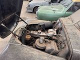 an old car with a broken engine in a parking lot