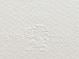 a close up of a piece of white paper with a bird on it