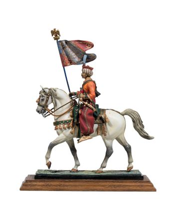 statue of a man riding a horse with a flag on top of it