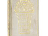 an old book with a gold design on the cover