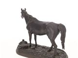 a statue of a horse that is standing on a rock
