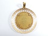 a close up of a gold coin on a white surface