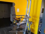 a yellow wall behind the exercise equipment in the gym