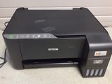 a black printer sitting on top of a counter next to a wall