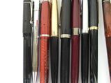 a lot of pens that are lined up on a table