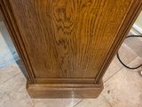 a wooden cabinet with a mirror on top of it