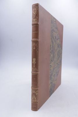 an old book sitting on top of a white surface with a white background