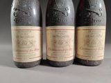 three bottles of wine sitting on top of a table next to each other
