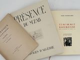 three books sitting on top of a white table next to each other