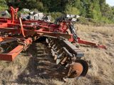 an image of a red tractor plow in a field