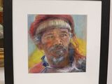 painting of a man with a beard and a red hat in a black frame