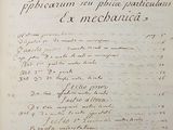 an old book with writing on it sitting on top of a table