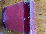 a red book sitting on top of a wooden table