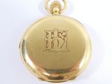 a gold pocket watch with a chinese writing on it