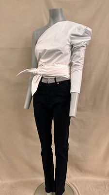 a mannequin wearing a white shirt and black pants