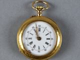 a gold pocket watch with roman numerals on it