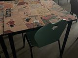 many chairs and tables in a room with a lot of papers on the table