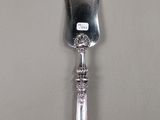 a silver spoon with a handle on a table