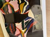 an image of a picture of a woman in a dress on a table