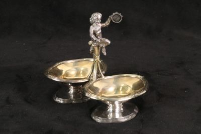 pair of silver plated candlesticks with a lady holding a tennis racquet