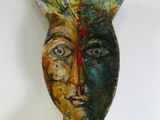 a colorful vase with a face on it on a table