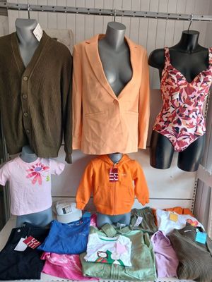 several mannequins and clothing displayed on display in a clothing store
