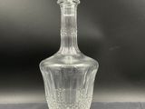 a close up of a clear glass bottle on a table