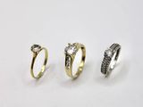 three different types of rings on a white surface