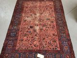 an antique persian rug is on the floor in a room