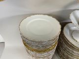 a lot of plates and cups sitting on a table