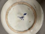 a white plate with a blue bird on it