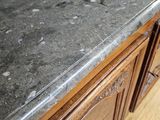a close up of a marble counter top on a wooden floor