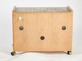 a small wooden box with a tile top on wheels