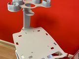 a laptop on top of a cart in front of a red wall