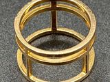 a close up of a gold ring on a black surface