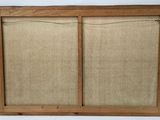 a close up of a picture of a wooden frame on a wall
