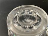 a glass jar with a glass lid on a table