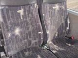 two seats in the front of a bus that are empty
