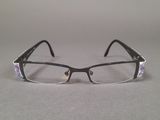 a pair of glasses sitting on a table next to each other
