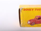 a red toy truck in a box on a white surface