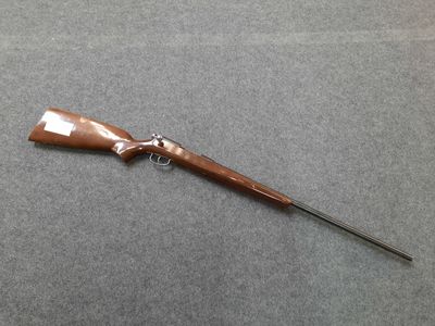 a rifle that is laying on a table