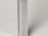 a metal object that is sitting on a white surface