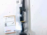a black and yellow pen in a package on a white surface