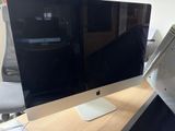 an apple computer sitting on top of a wooden desk next to a computer monitor
