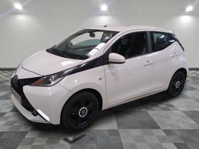 a picture of a white toyota yaris parked on a checkered floor