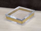 clear acrylic box with gold edges on a wooden table