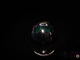 an image of a glass ball on a black surface